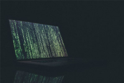 Green digital code on a laptop screen