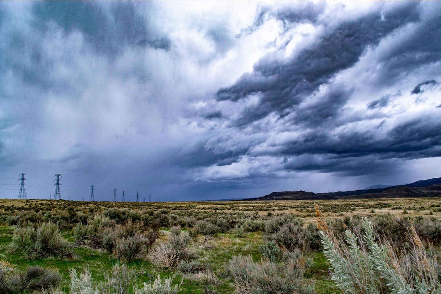 A wide open field with a bright blue sky