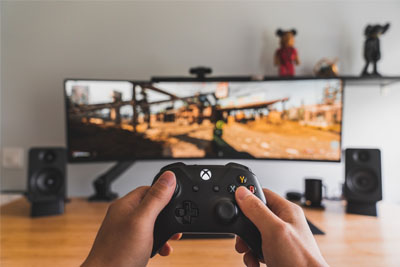 Someone holding a video game controller while playing games