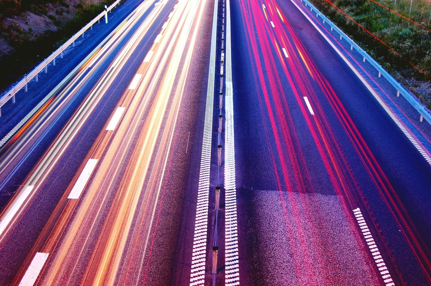 A symmetrical highway with light trails, symbolizing equal and high-speed internet connectivity